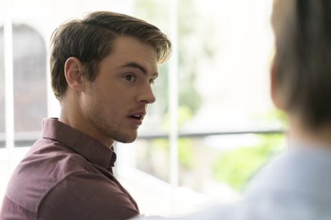 Young man speaking with his family doctor