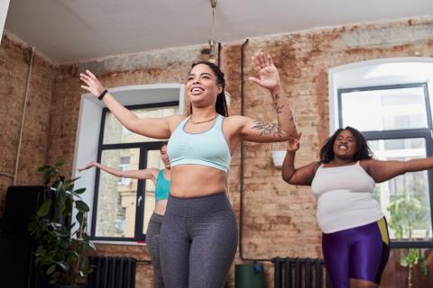 Three friends doing a workout at home together