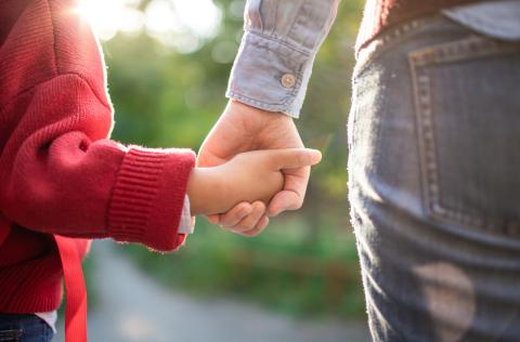 Two people holding hands