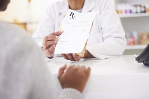 Doctors handing a prescription to a patient