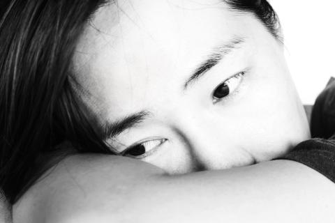 Distraught woman leaning on her arm