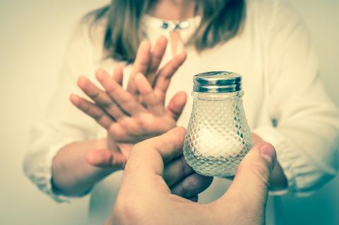 Girl stopping the intake of salt in her diet