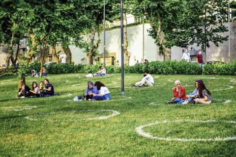 Groups of people physically distancing in a park