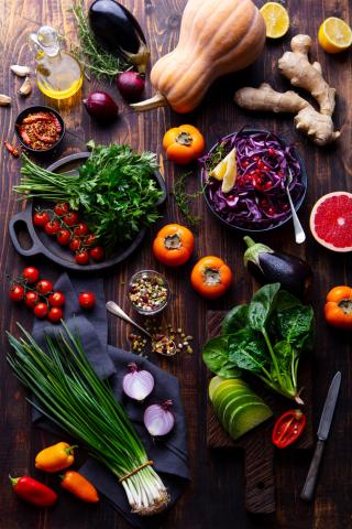Assortment of fresh raw vegetables on a wooden background