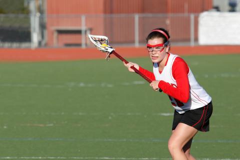 Fierce girl playing lacrosse