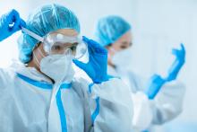 Doctors put on personal protective equipment (PPE)