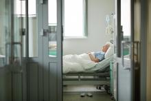 A senior in a hospital bed