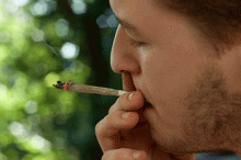 A man smokes marijuana