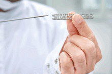 A doctor holds a heart stent