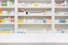 Shelves in a pharmacy with an assortment of medications
