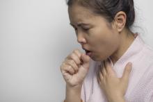 A woman is coughing
