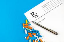 A prescription slip and a variety of medications