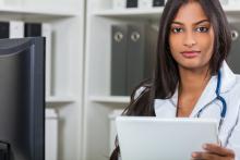 A health care administrator works at a computer