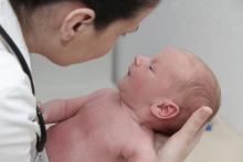 A doctor examines a baby