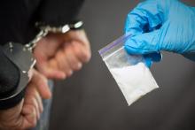 A man with drugs is being handcuffed