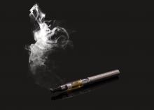 An electronic cigarette and a cloud of smoke