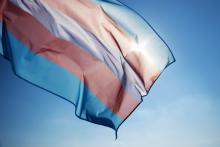 The transgender flag against a blue sky