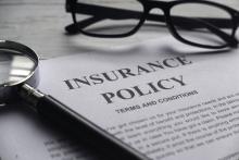 An insurance policy sits on a table