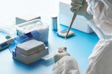 A lab technician conducts polymerase chain reaction (PCR) testing