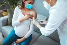 A pregnant woman receives a COVID-19 vaccination