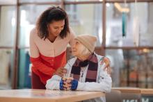 A caregiver attends to a senior