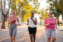 A diverse group of women jogging and chatting.