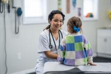 A doctor tends to a young patient.