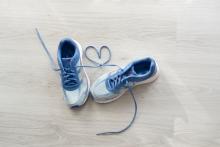 Blue sport shoes with the laces making a heart