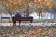 Lonely senior man sitting on a park bench