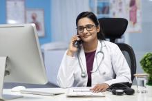 Female doctor talking on phone at clinic