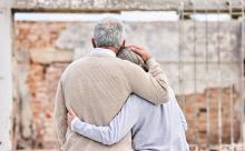A senior couple hugging