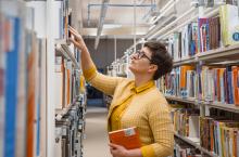 Librarian looking through the stacks