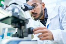 Scientist Using Microscope in Laboratory - 