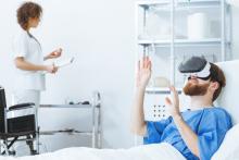 Bed ridden male patient wearing virtual reality goggles