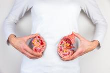 Woman showing the innards of kidneys by holding the two halves where her kidneys would be on the body